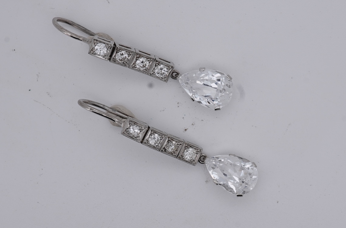 A pair of white metal and four stone diamond set earrings, each with a cubic zirconia pear shaped drop, overall 42mm.